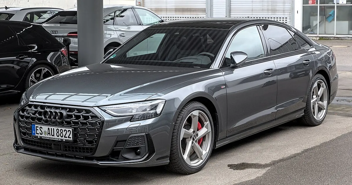 Grey standard-wheelbase Audi A8 D5 facelift viewed from the front and side