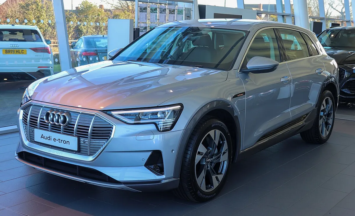 Grey original Audi e-tron electric SUV viewed from the front and side