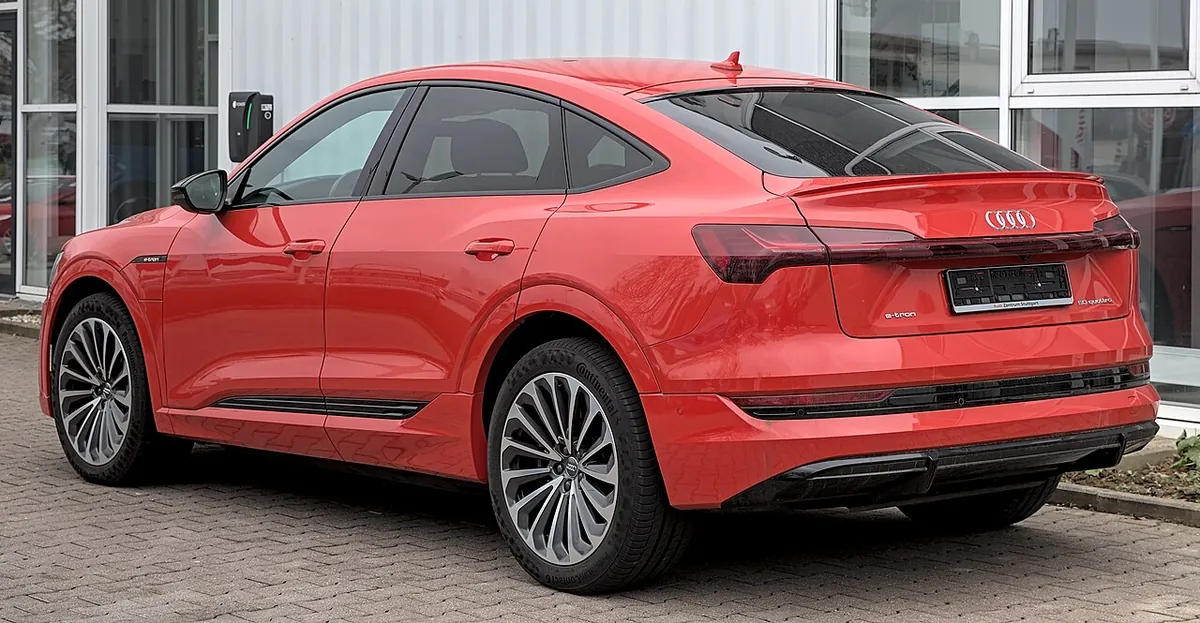 Red Audi e-tron Sportback electric SUV viewed from the rear and side