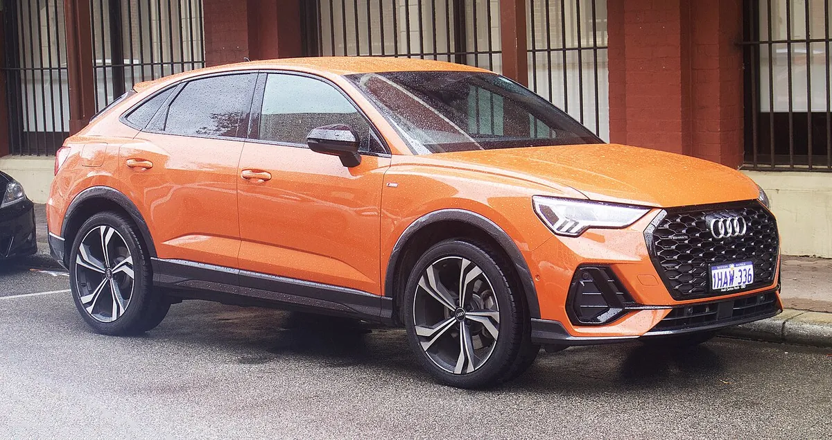 Orange Audi Q3 Sportback F3 viewed from the front and side