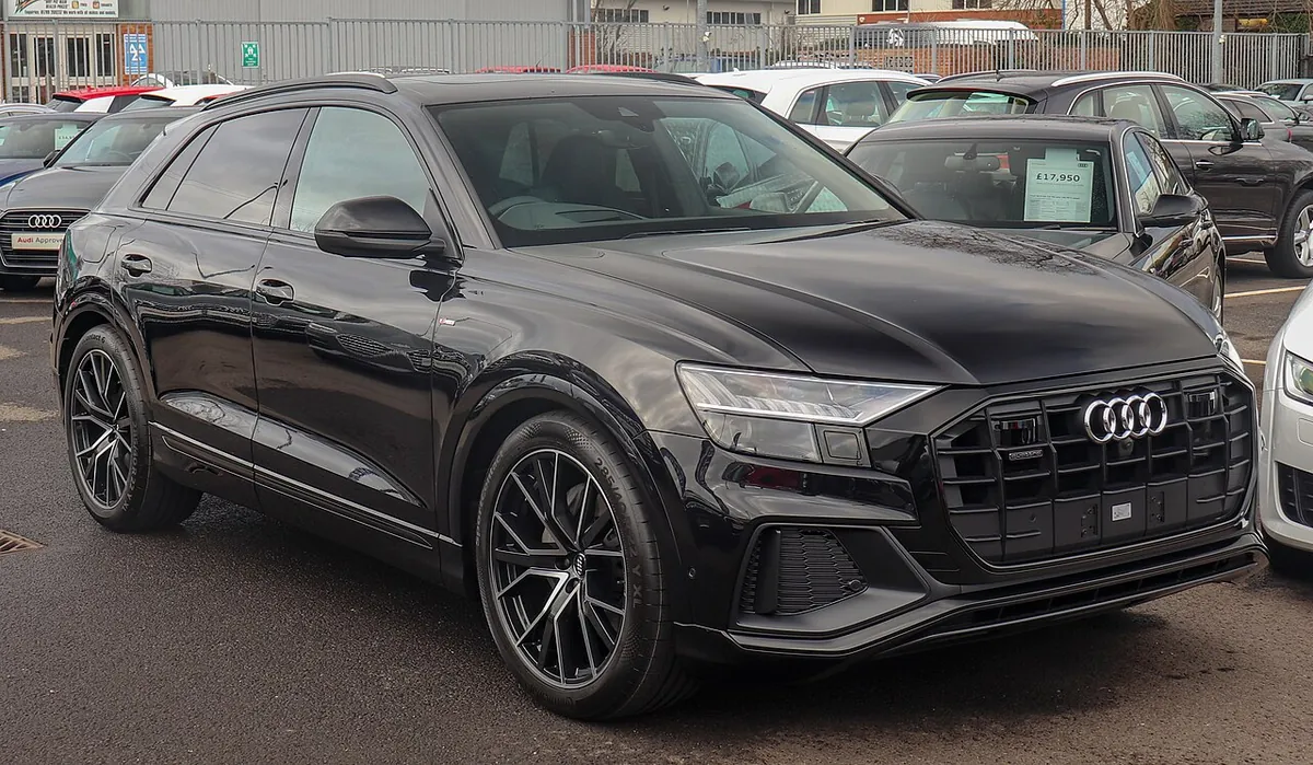 Black Audi Q8 combustion SUV viewed from the front and side