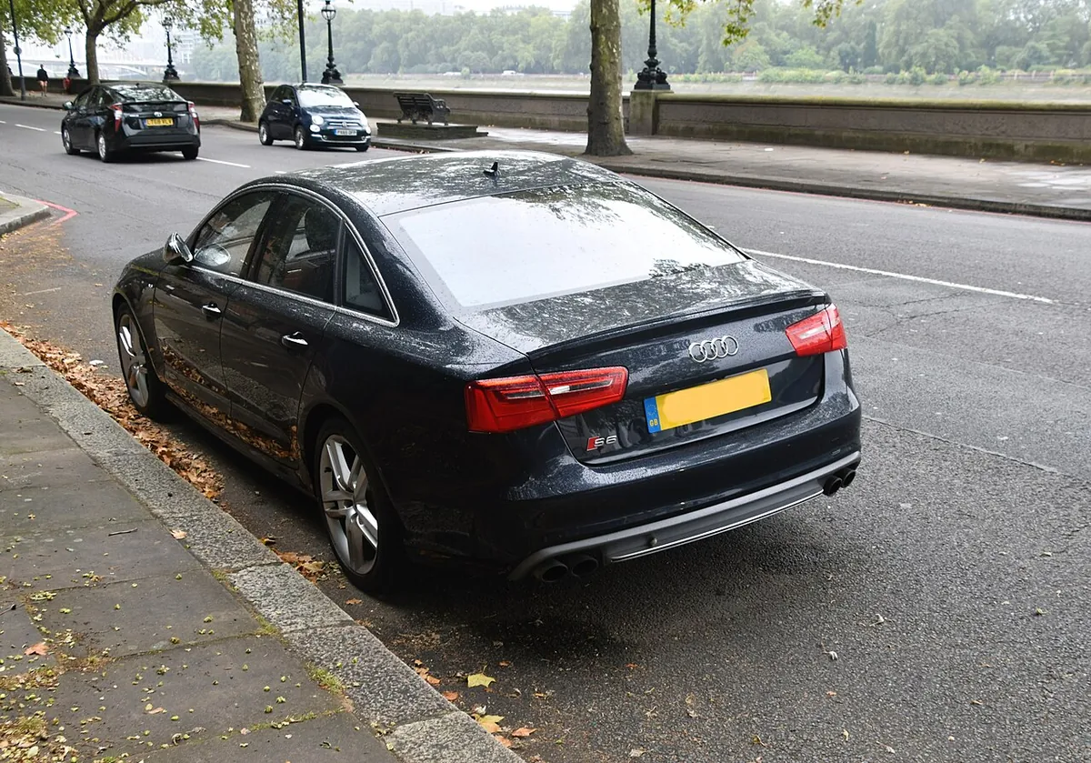Black Audi S6 C7 performance sedan viewed from the rear and side