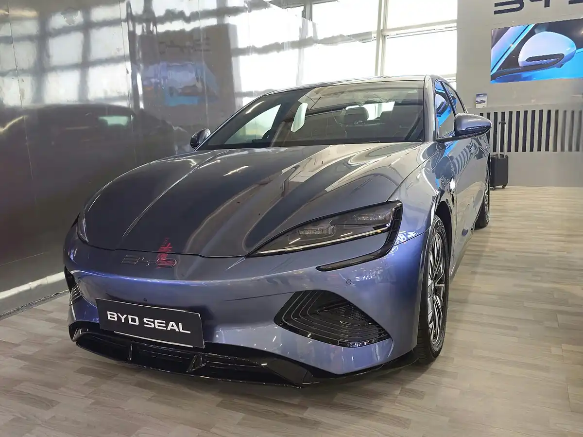 Blue BYD SEAL electric sedan viewed from the front and side in an Indian showroom