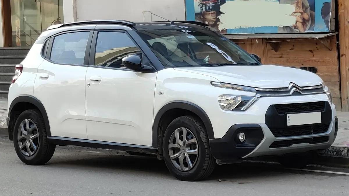 White earlier India-market Citroën C3 Feel viewed from the front and side in Bengaluru