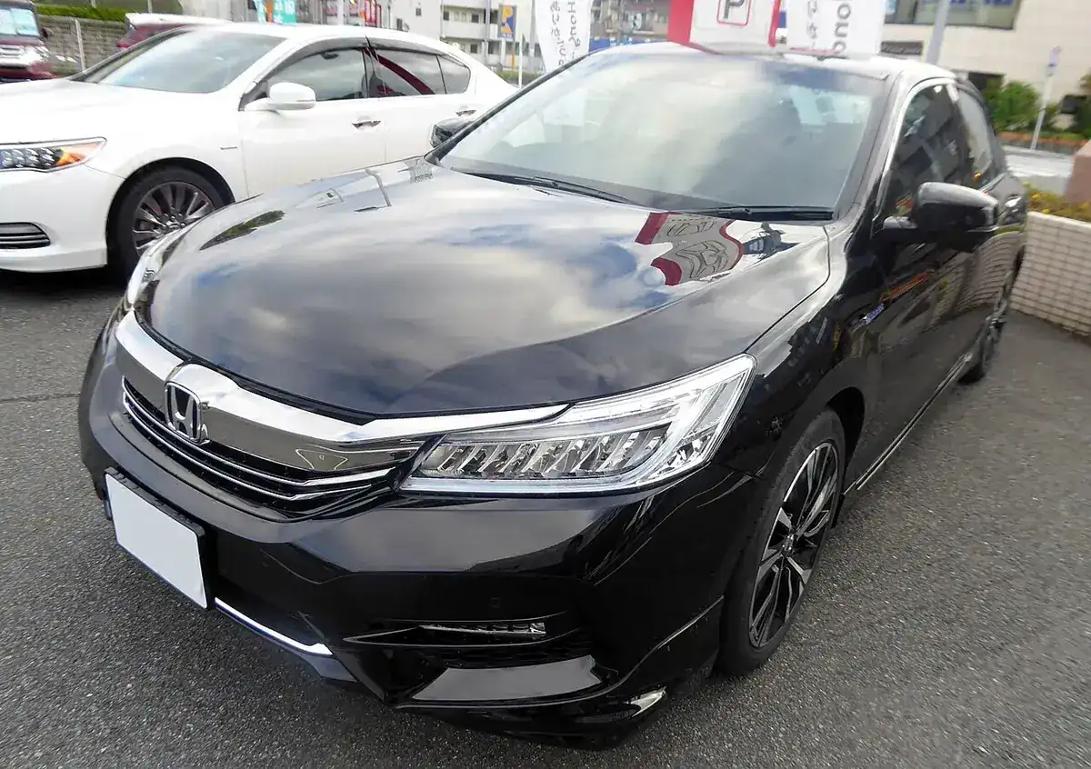 Black ninth-generation Honda Accord Hybrid EX viewed from the front and side