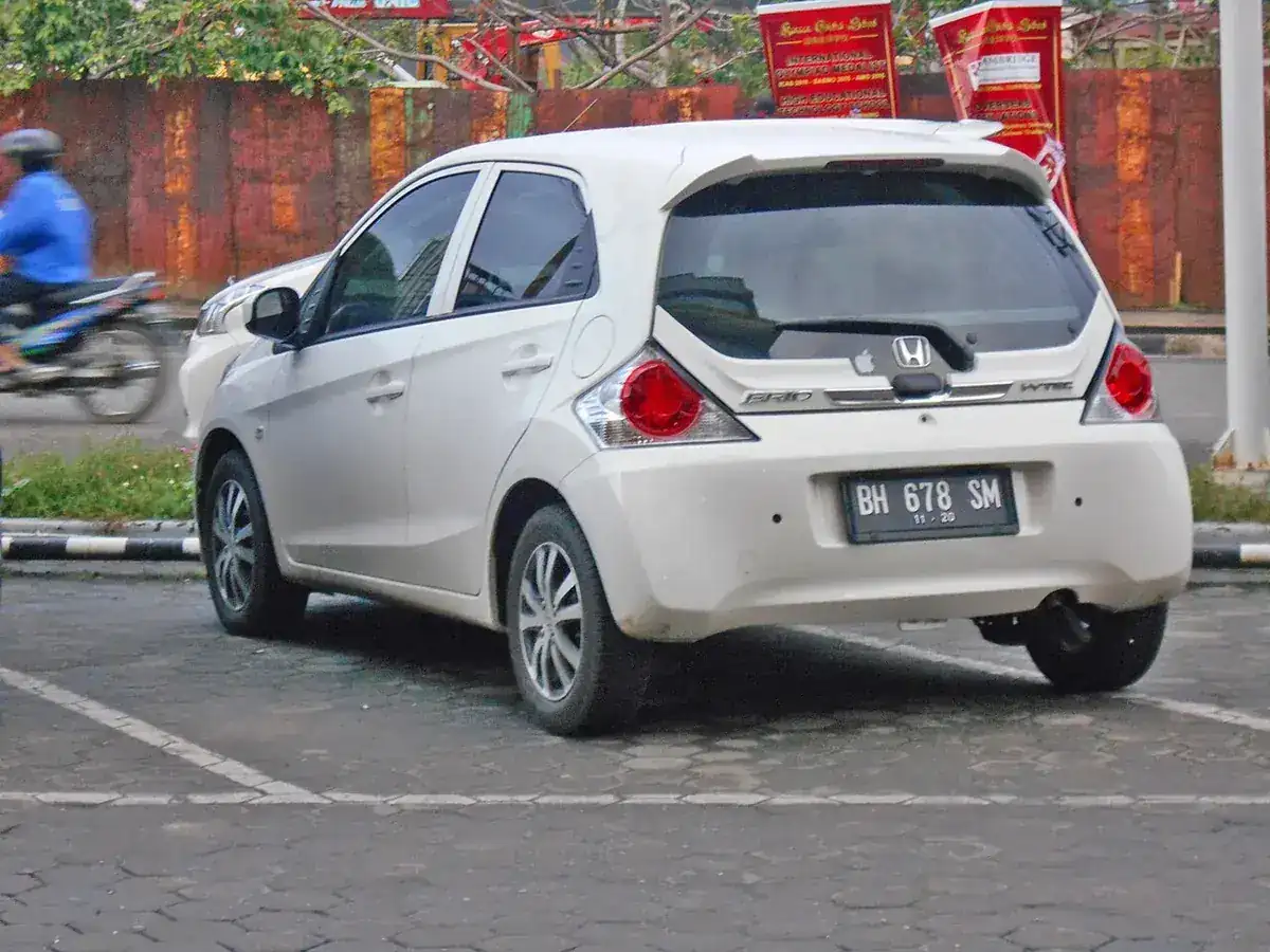 White first-generation Honda Brio viewed from the rear and side in Indonesia