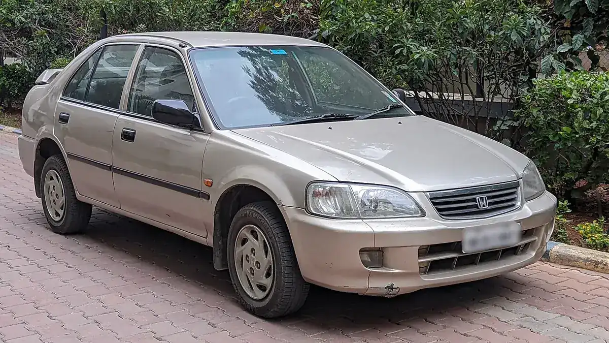 Beige 2000 Honda City EXi viewed from the front and side in India
