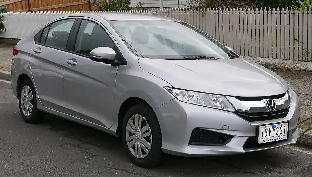 Silver 2014 Honda City VTi viewed from the front and side in Australia