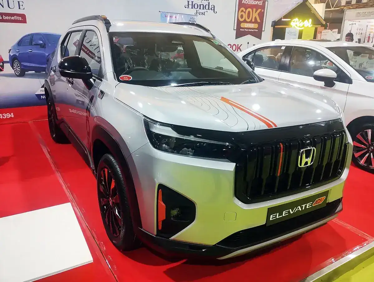 Silver Honda Elevate ADV edition viewed from the front and side at a 2025 Bangalore auto show