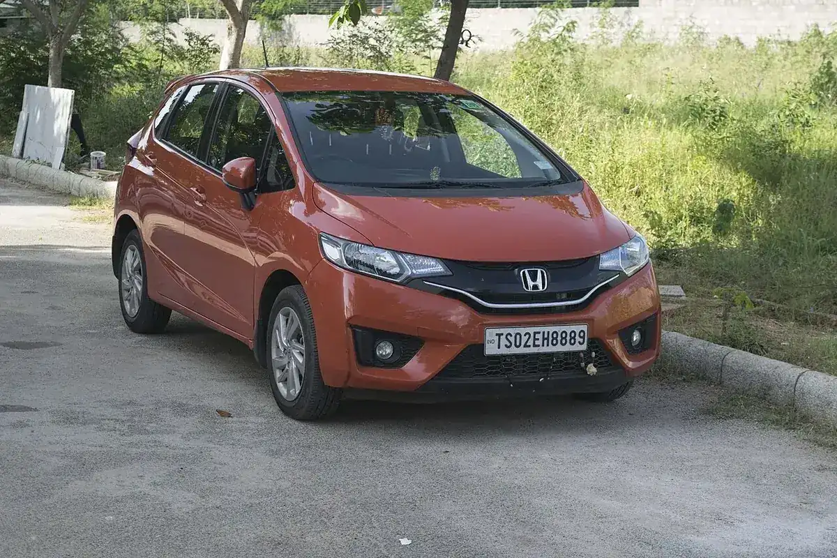 Orange third-generation Honda Jazz viewed from the front and side in India