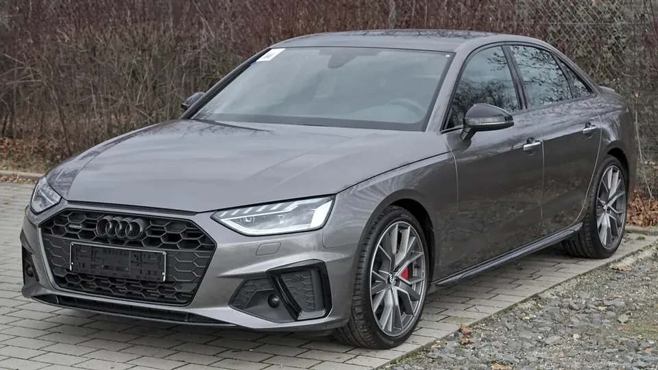 Grey Audi A4 B9 facelift sedan viewed from the front and side