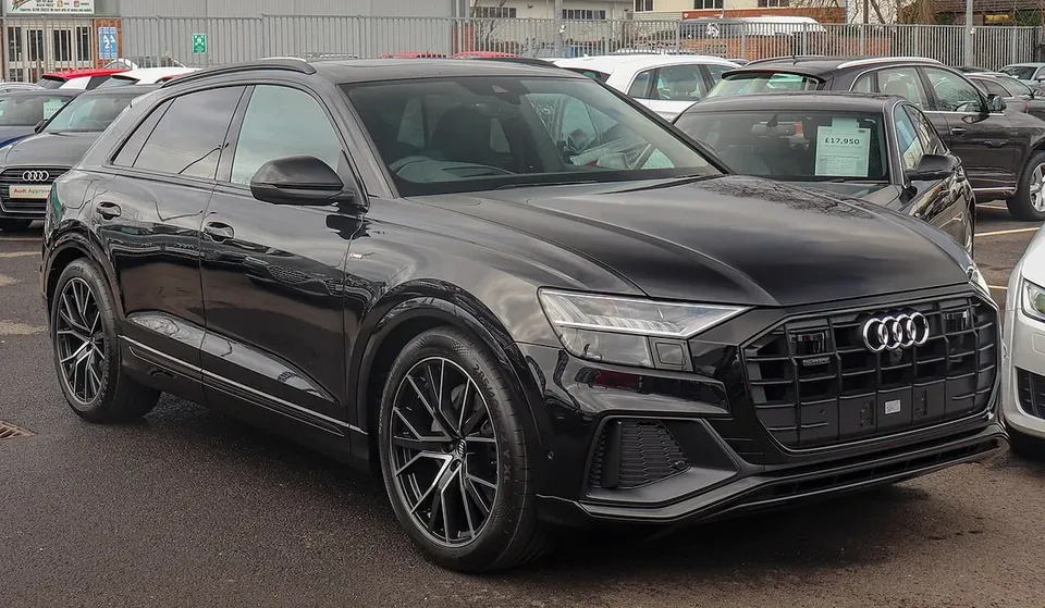 Black Audi Q8 combustion SUV viewed from the front and side