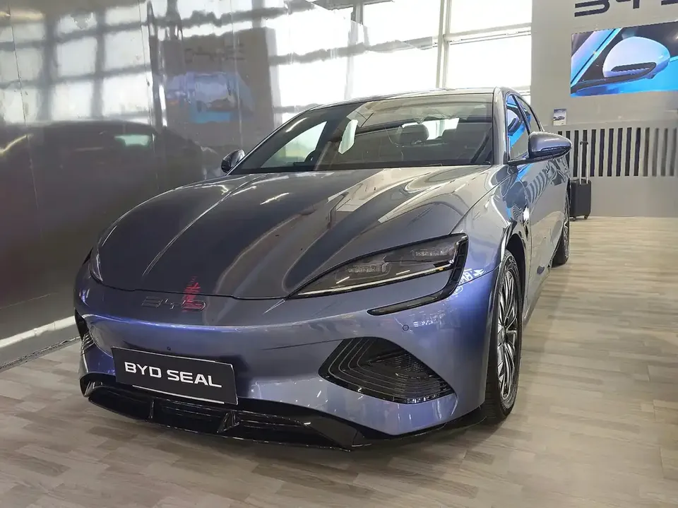 Blue BYD SEAL electric sedan viewed from the front and side in an Indian showroom