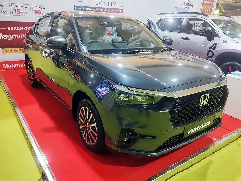 Dark grey third-generation Honda Amaze viewed from the front and side at a Bangalore auto show