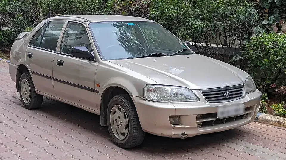 Beige 2000 Honda City EXi viewed from the front and side in India