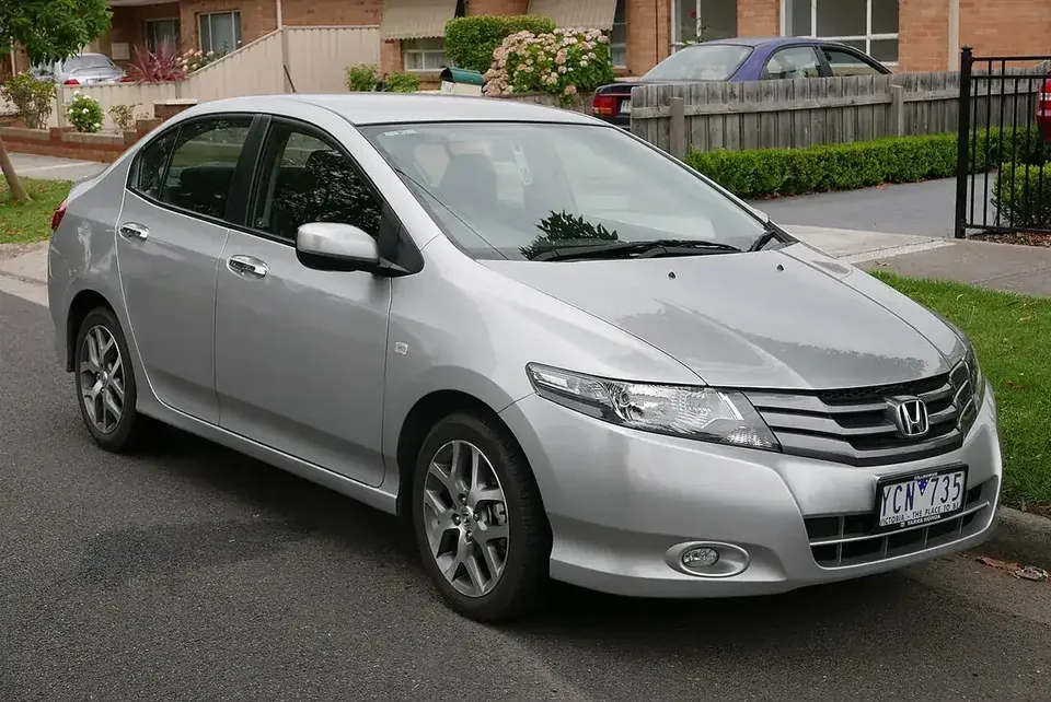Silver 2010 Honda City VTi-L viewed from the front and side in Australia