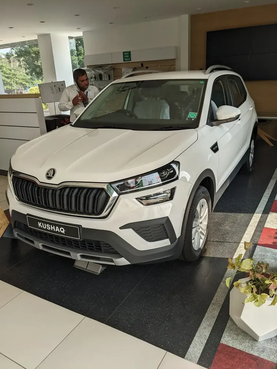 White Škoda Kushaq seen from the front in an Indian showroom