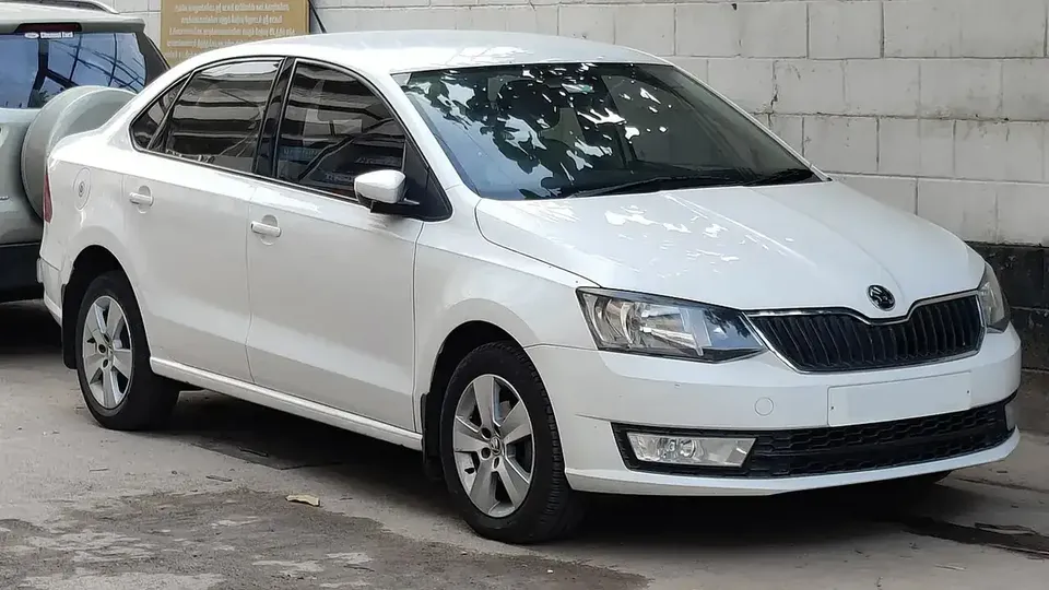 White Indian Škoda Rapid sedan viewed from the front and side in Coimbatore