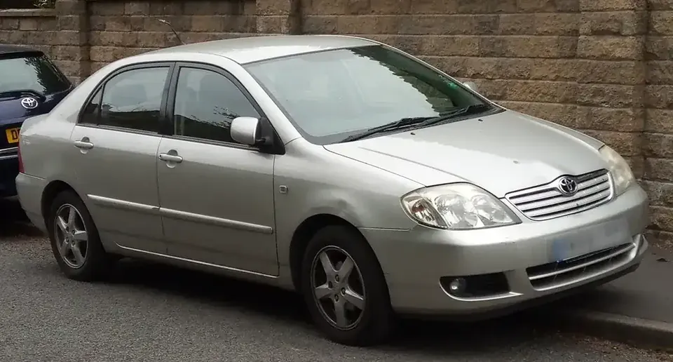 Silver 2004 Toyota Corolla E120 sedan viewed from the front and side