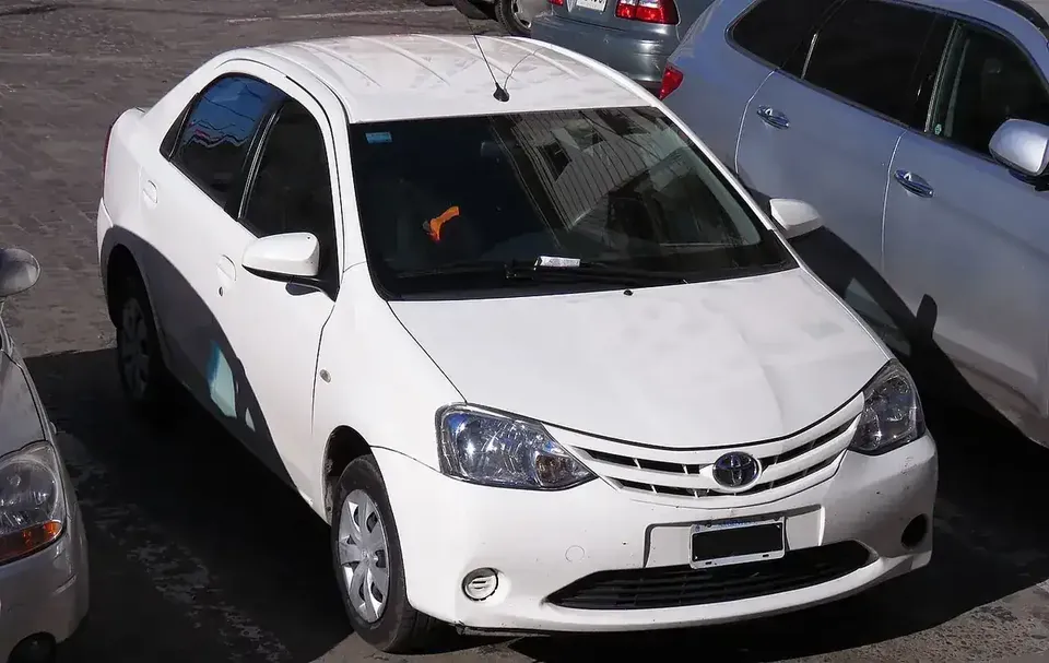 White Toyota Etios sedan viewed from the front and side from above