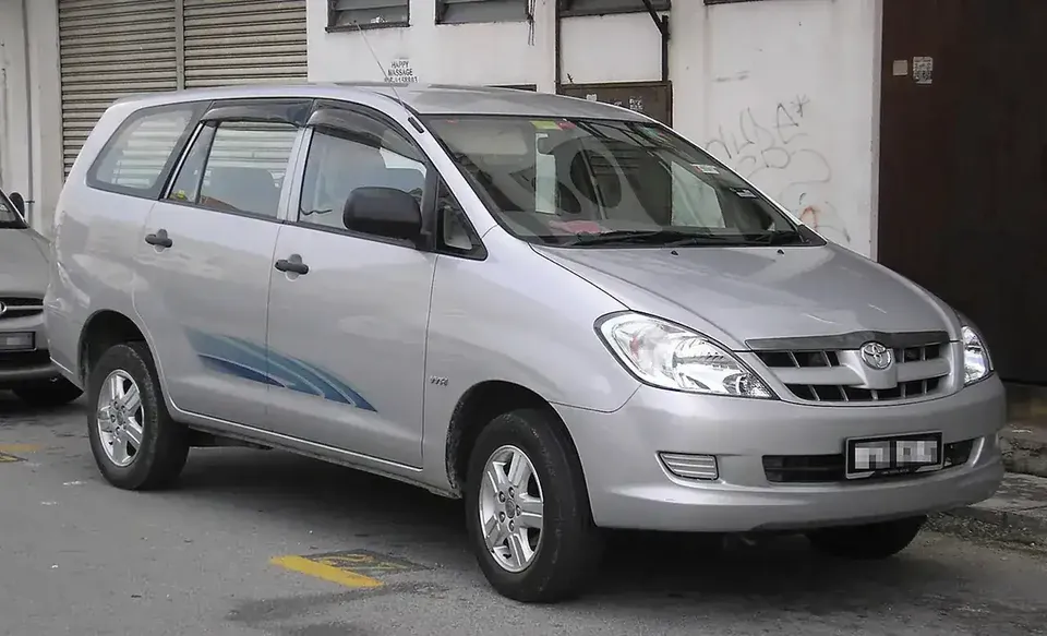 Silver first-generation Toyota Innova viewed from the front and side