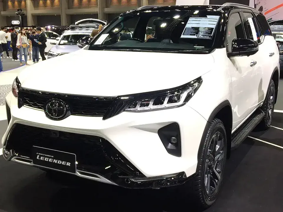 White and black 2020 Toyota Fortuner Legender viewed from the front and side at a motor show