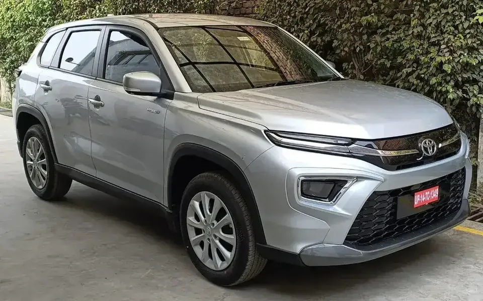 Silver Toyota Urban Cruiser Hyryder viewed from the front and side in Goa