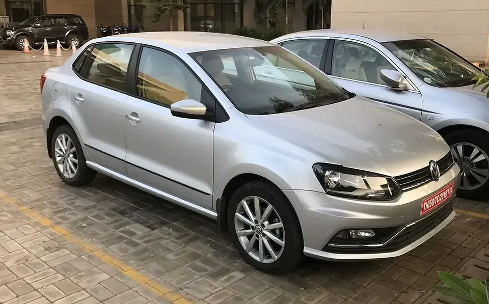 Silver Volkswagen Ameo compact sedan viewed from the front and side