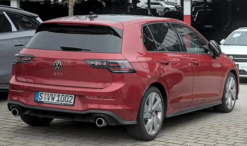 Red Volkswagen Golf GTI Mk8 facelift viewed from the rear and side