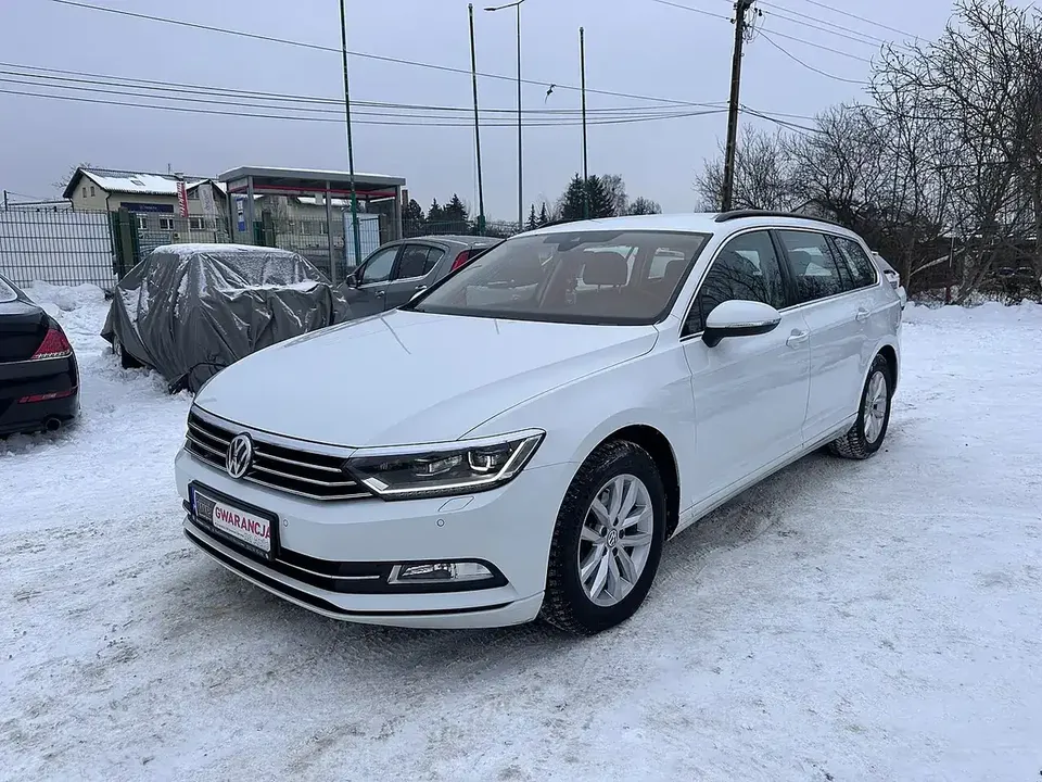 White Volkswagen Passat B8 sedan viewed from the front and side on snow