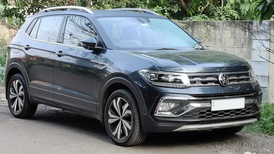 Grey pre-2026 Volkswagen Taigun viewed from the front and side in Coimbatore