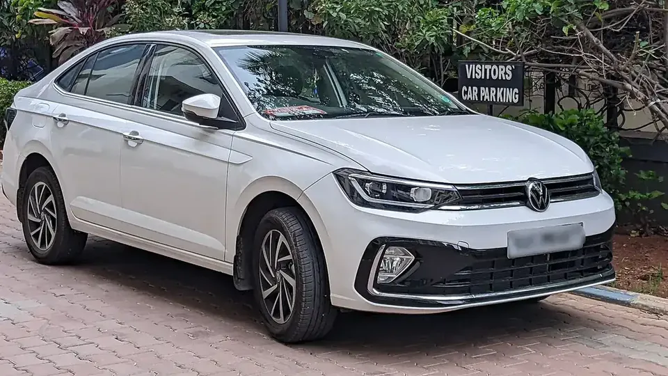 White Indian Volkswagen Virtus sedan viewed from the front and side