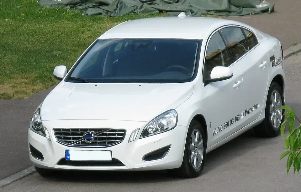 White Volvo S60 second-generation sedan seen from the front and side
