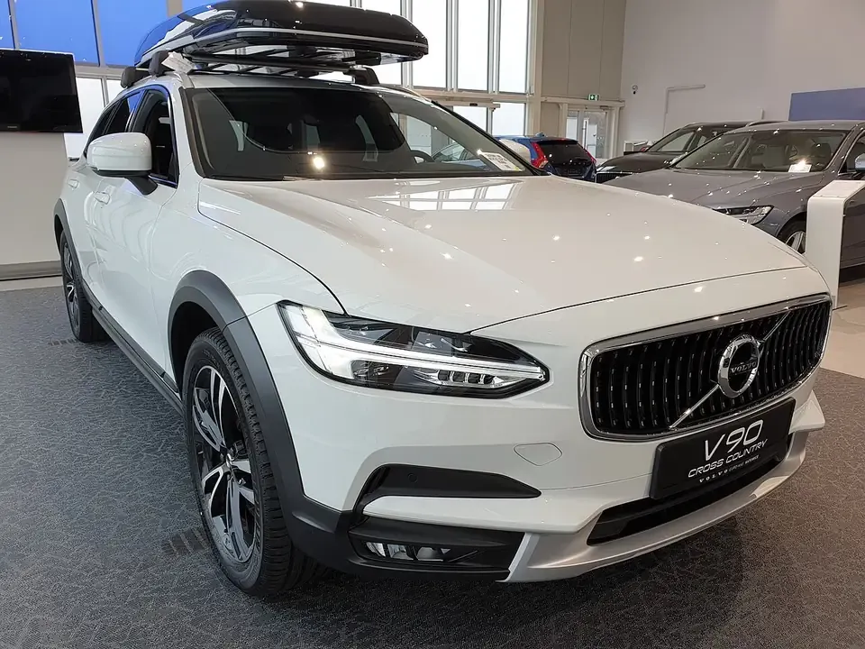 White Volvo V90 Cross Country estate seen from the front and side