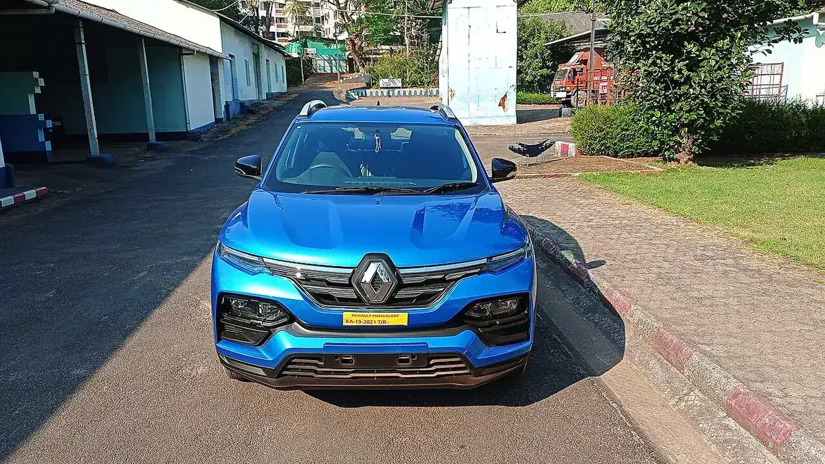 Blue 2021 Renault Kiger seen from the front beside a street