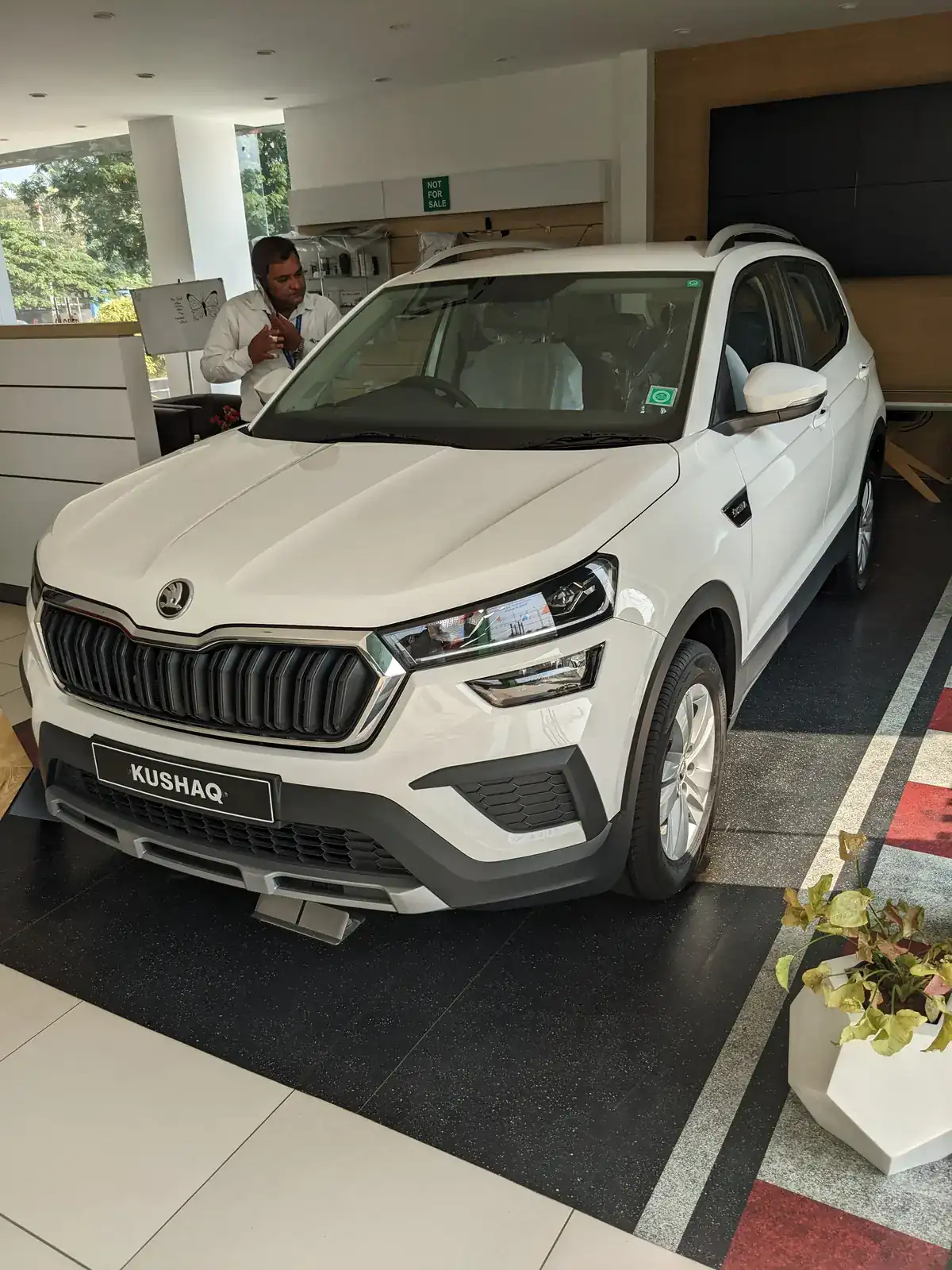 White Škoda Kushaq seen from the front in an Indian showroom