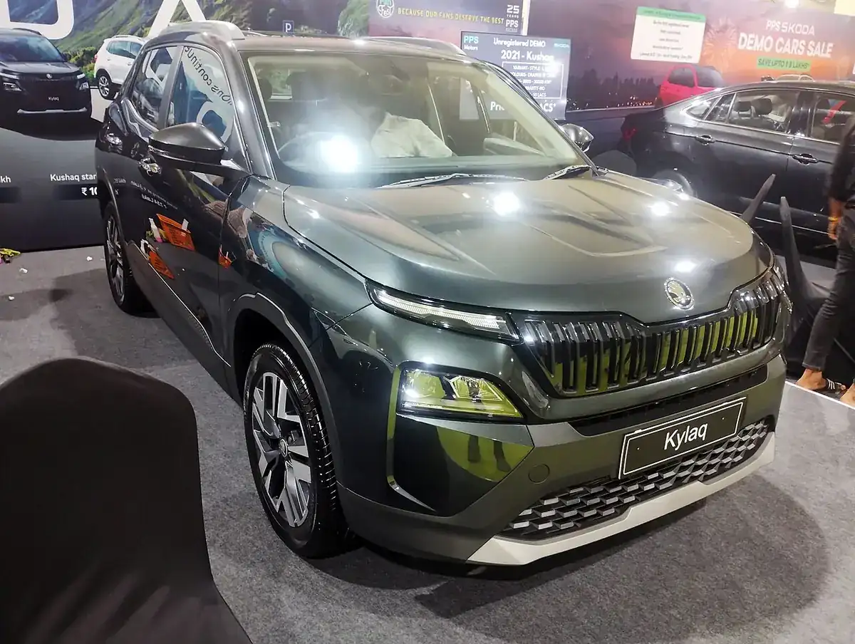 Green Škoda Kylaq seen from the front at a Bangalore auto show