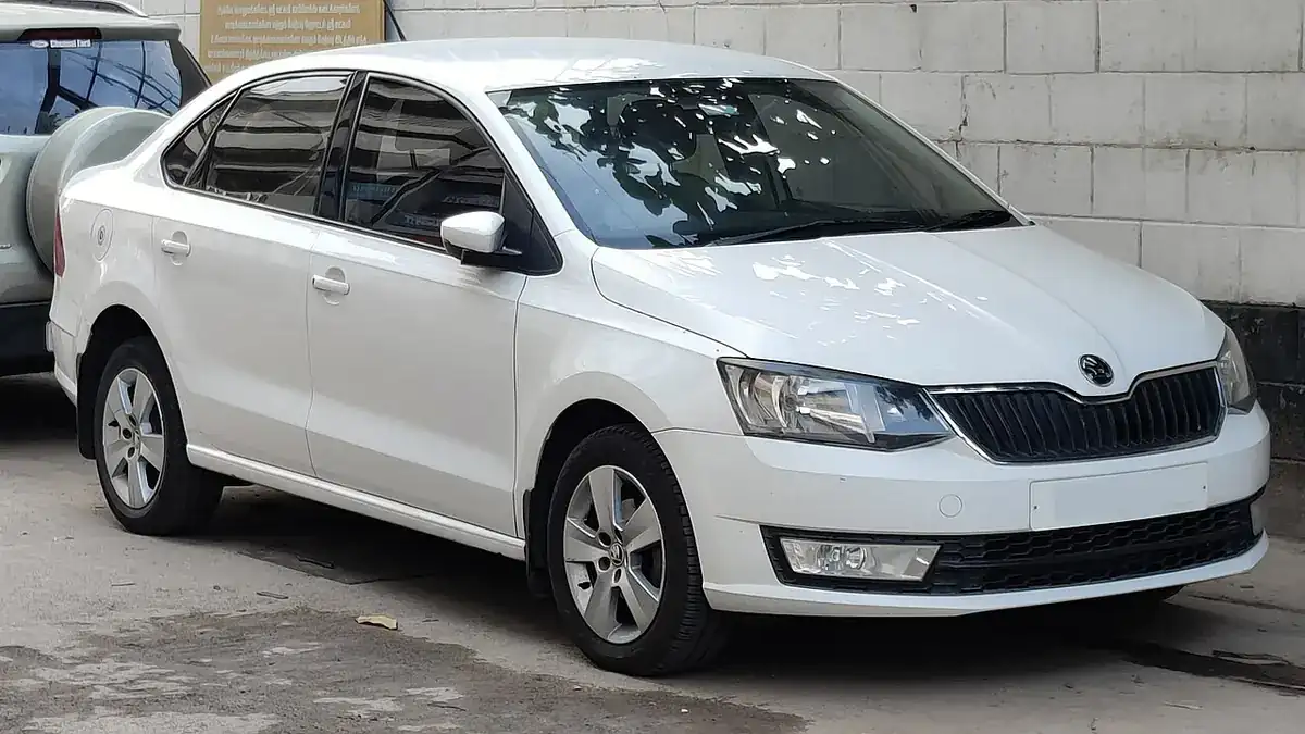 White Indian Škoda Rapid sedan viewed from the front and side in Coimbatore