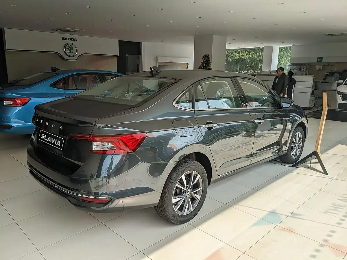 Grey Škoda Slavia viewed from the rear and side in a showroom