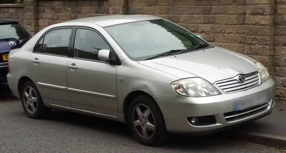 Silver 2004 Toyota Corolla E120 sedan viewed from the front and side