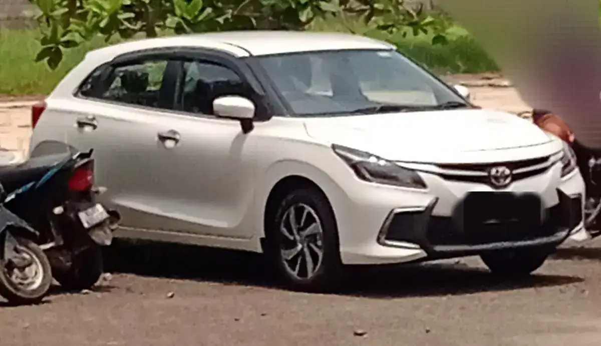 White second-generation Toyota Glanza viewed from the front and side