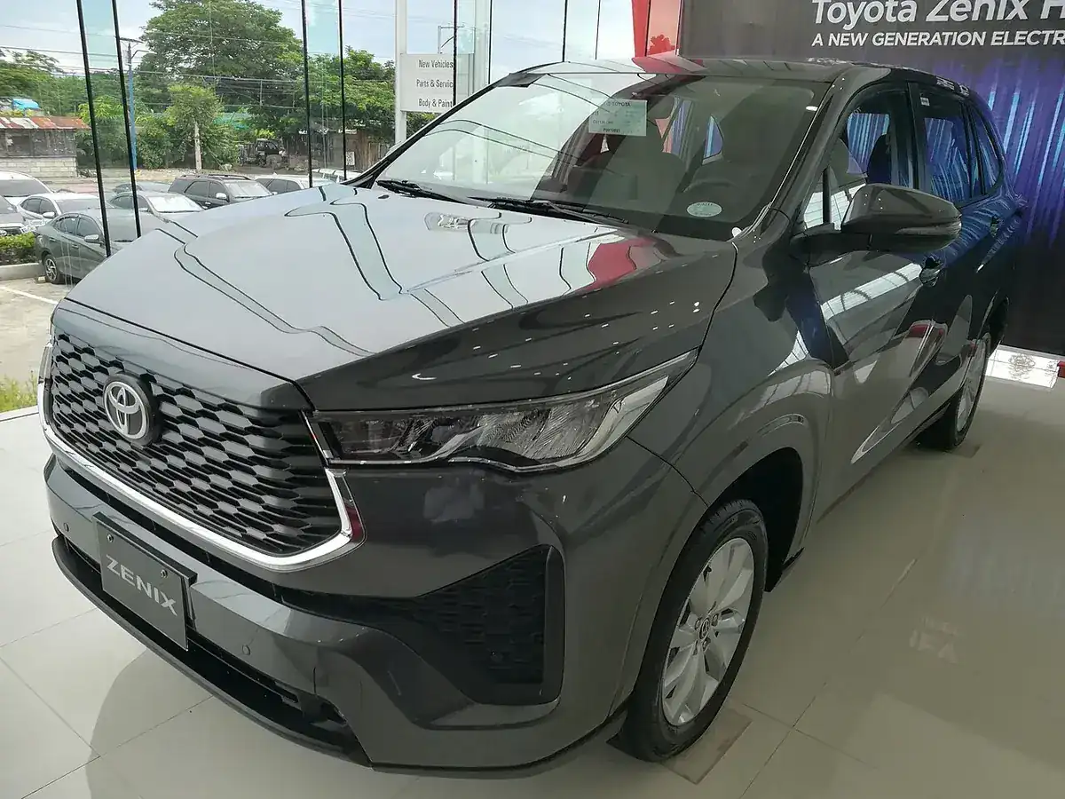 Grey 2023 Toyota Zenix 2.0 V viewed from the front and side in a showroom