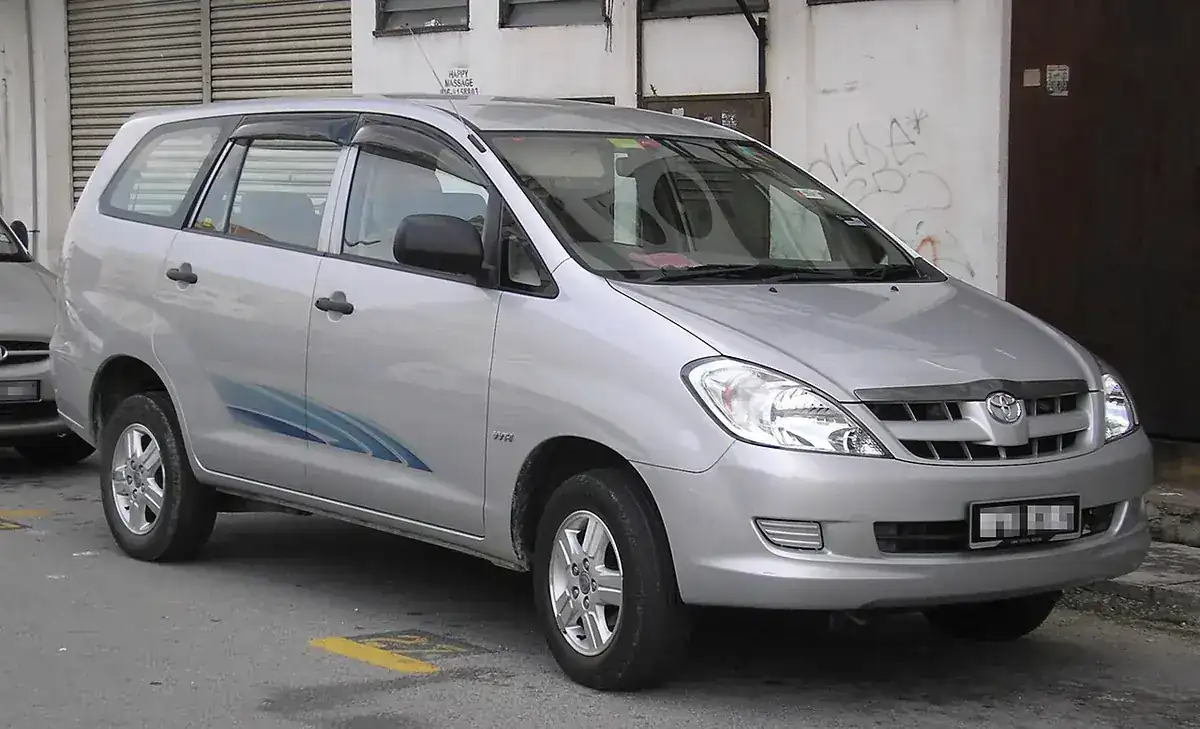 Silver first-generation Toyota Innova viewed from the front and side