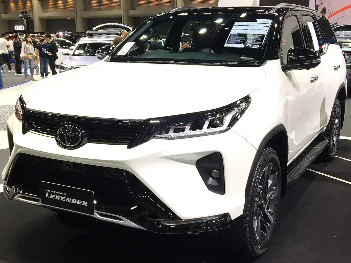 White and black 2020 Toyota Fortuner Legender viewed from the front and side at a motor show