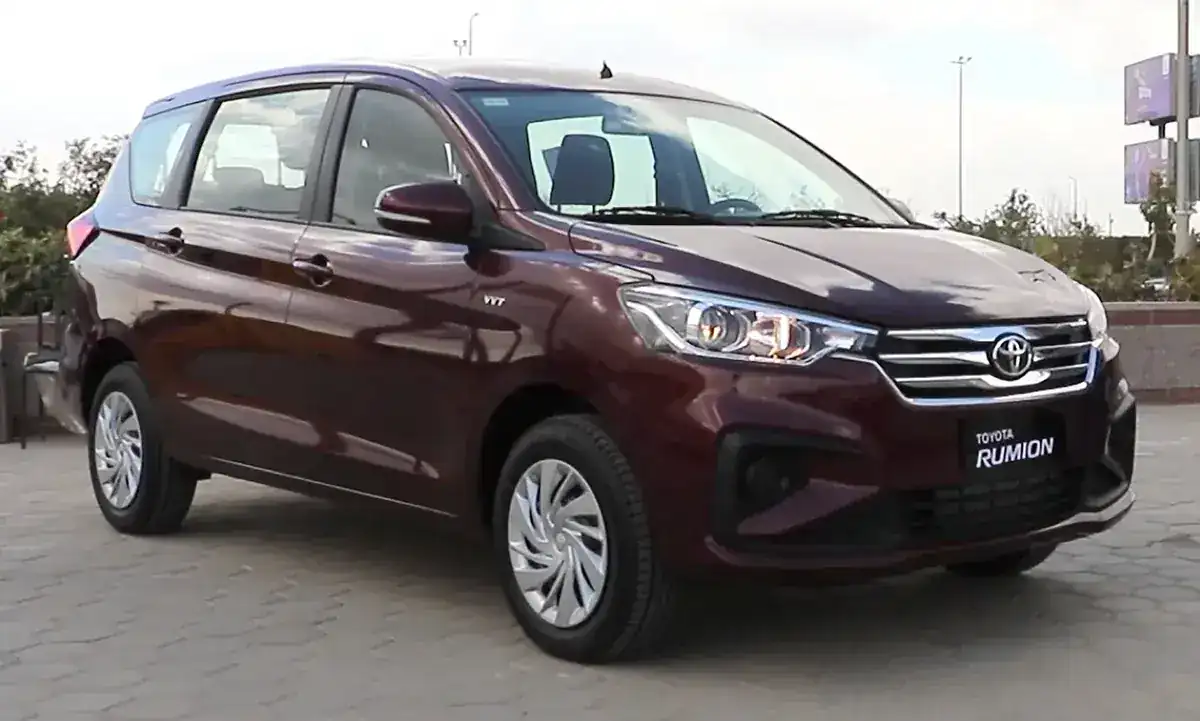Maroon 2022 Toyota Rumion Active MPV viewed from the front and side in Egypt