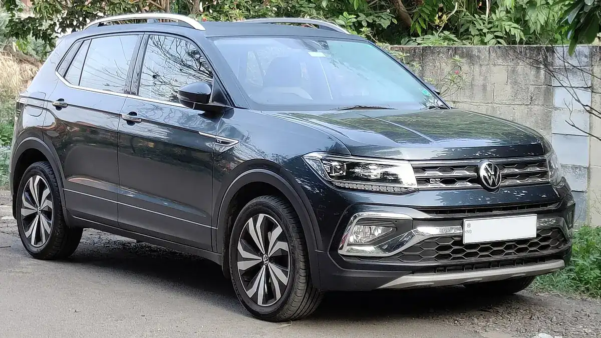 Grey pre-2026 Volkswagen Taigun viewed from the front and side in Coimbatore