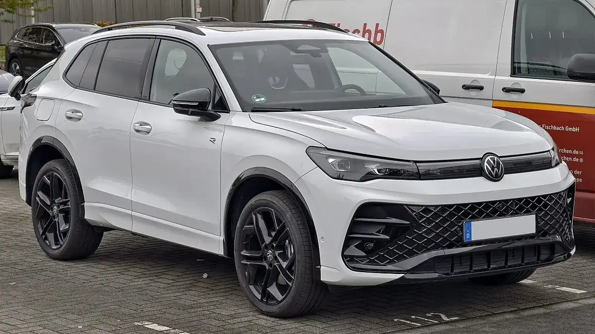 White third-generation Volkswagen Tiguan R-Line viewed from the front and side