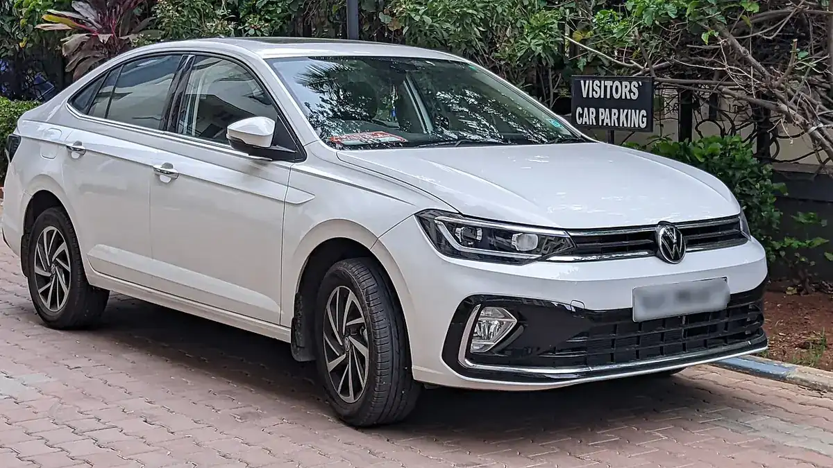 White Indian Volkswagen Virtus sedan viewed from the front and side