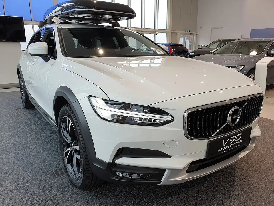 White Volvo V90 Cross Country estate seen from the front and side